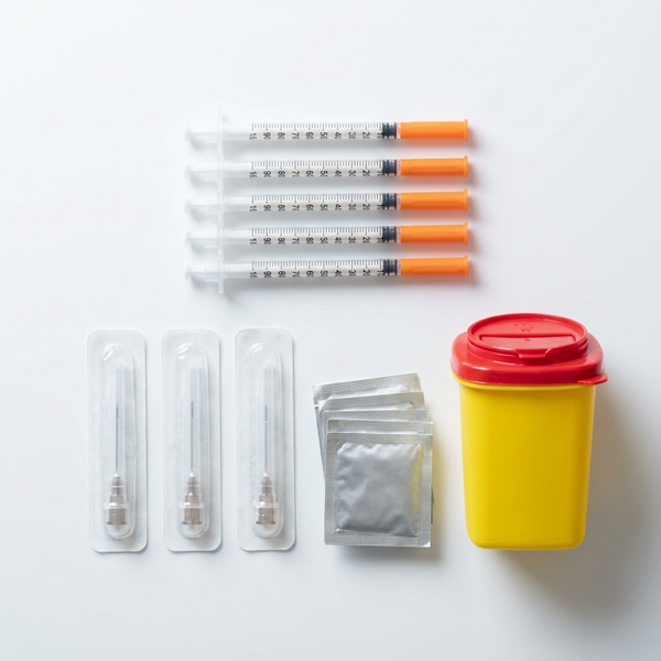 Research Chem Bundle Kit flat lay: insulin syringes, draw needles, alcohol prep pads and a 1.4 L sharps bin