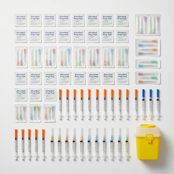 Monthly Resupply Kit flat lay: bulk prep pads, needles, syringes and a 1.8 L sharps bin